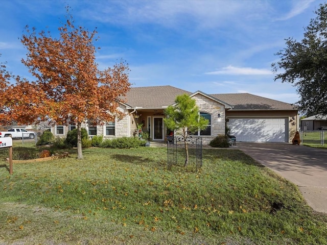 view of front of house featuring a garage and a front lawn