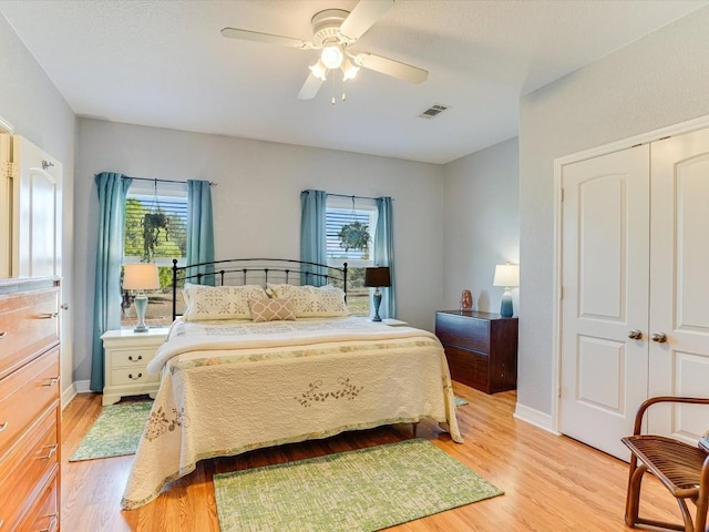 bedroom featuring ceiling fan, a closet, and light hardwood / wood-style floors