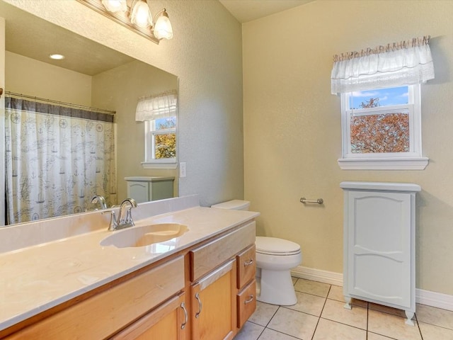 bathroom with tile patterned flooring, vanity, and toilet