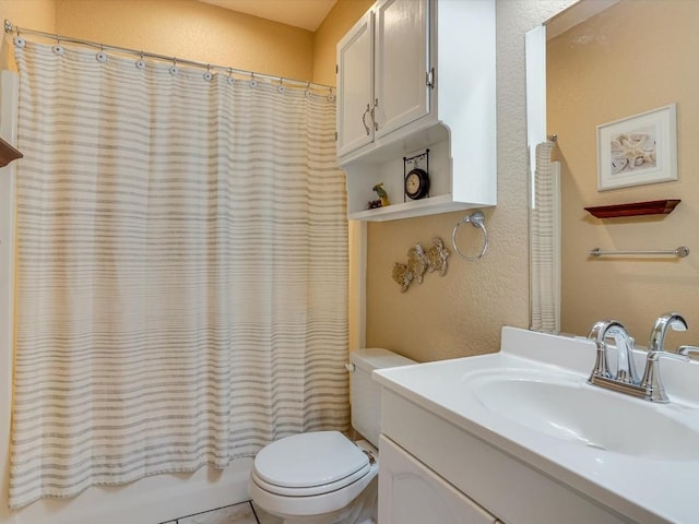 full bathroom featuring shower / bath combo, vanity, and toilet