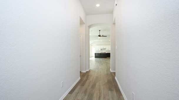 hallway with hardwood / wood-style floors