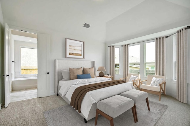 192 Bay Breeze Dr, Kyle, TX 78640 - bedroom featuring light carpet, connected bathroom, and high vaulted ceiling