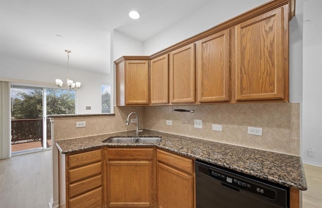 kitchen featuring black dishwasher, light hardwood / wood-style floors, dark stone countertops, and sink