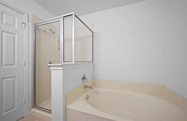 bathroom featuring tile patterned floors and shower with separate bathtub