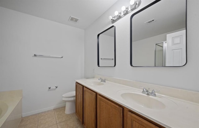 bathroom with toilet, vanity, tile patterned floors, and a bathing tub