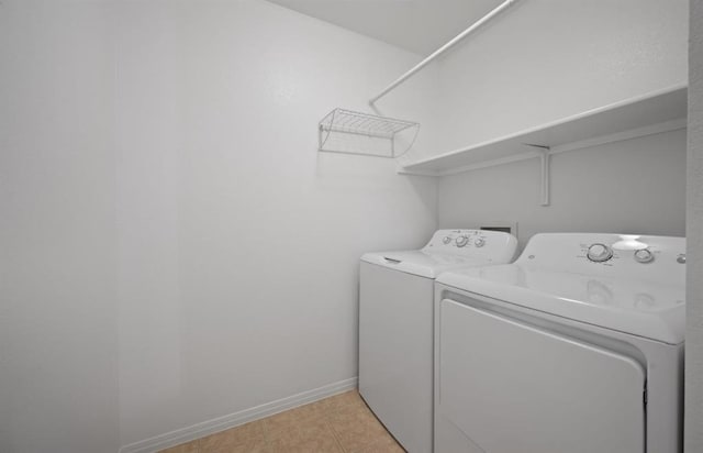 clothes washing area with light tile patterned floors and independent washer and dryer