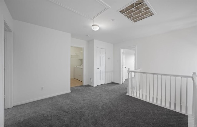 empty room featuring dark carpet and separate washer and dryer