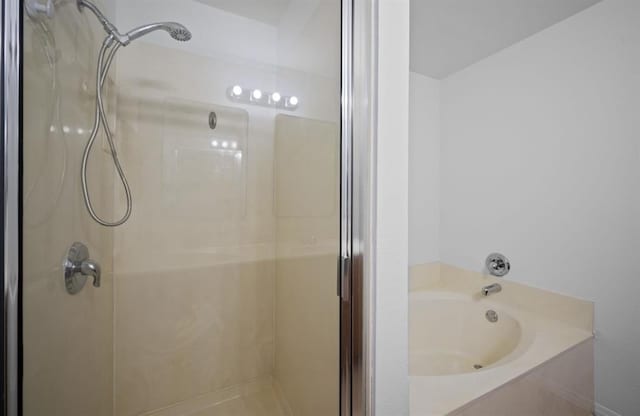 bathroom with shower with separate bathtub