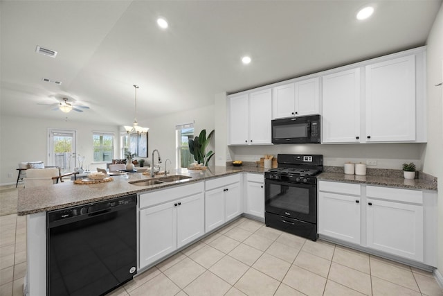 14121 Fallsprings Way, Manor, TX 78653 - kitchen with black appliances, a peninsula, white cabinetry, light tile patterned floors, and recessed lighting