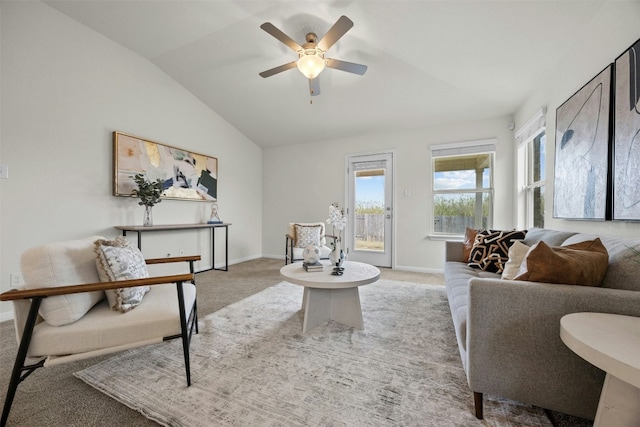 living room featuring ceiling fan, light colored carpet, and vaulted ceiling