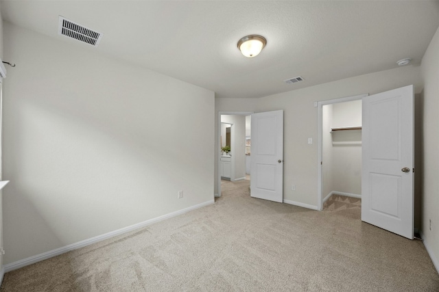 14121 Fallsprings Way, Manor, TX 78653 - unfurnished bedroom featuring light colored carpet, a walk in closet, and a closet