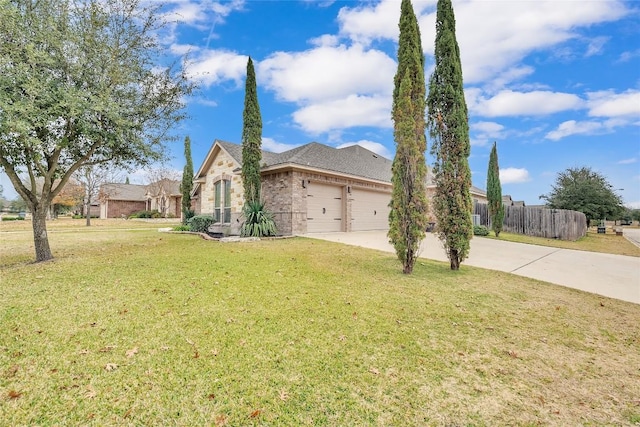 view of front of property featuring a front lawn and a garage