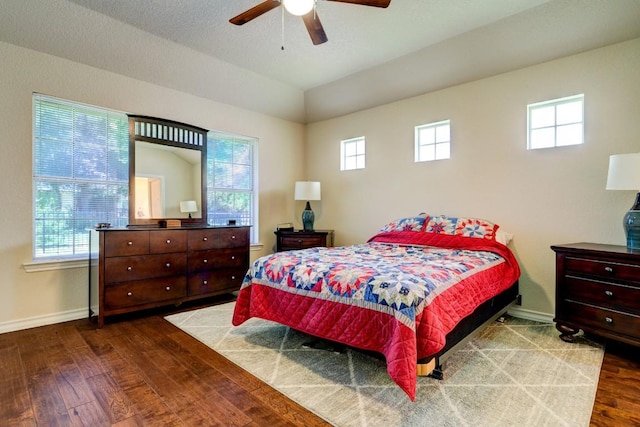 bedroom featuring ceiling fan, lofted ceiling, and hardwood / wood-style flooring