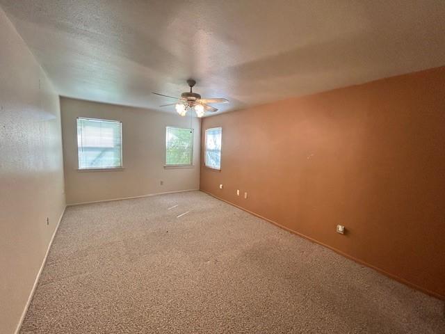 unfurnished room featuring carpet and ceiling fan