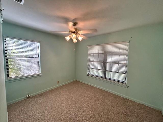 empty room with carpet flooring and ceiling fan