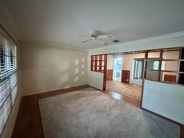 spare room featuring hardwood / wood-style flooring, ceiling fan, and ornamental molding