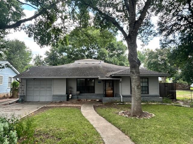 ranch-style house with a front lawn and a garage