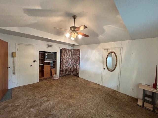 unfurnished bedroom featuring ceiling fan, lofted ceiling, and carpet floors