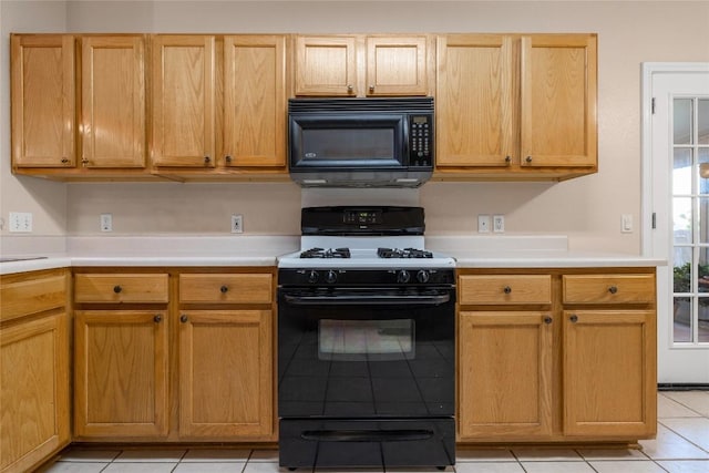 kitchen with black appliances and light tile patterned floors