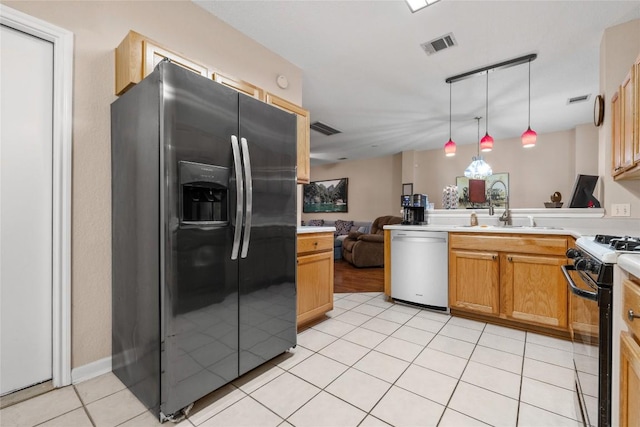 kitchen featuring white dishwasher, refrigerator with ice dispenser, light tile patterned floors, range, and hanging light fixtures