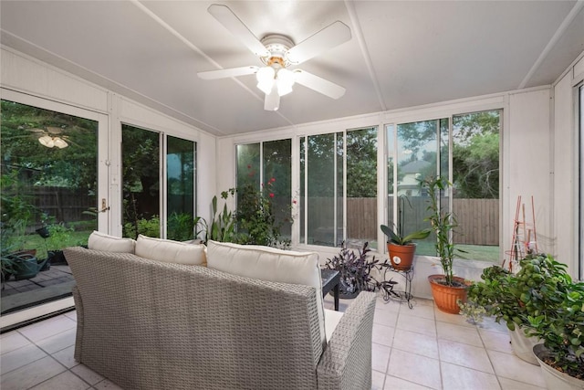 sunroom with ceiling fan and lofted ceiling