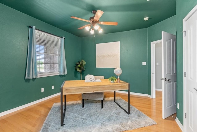 home office with hardwood / wood-style flooring and ceiling fan