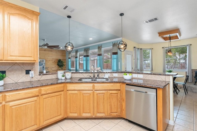 kitchen with ceiling fan, sink, stainless steel dishwasher, kitchen peninsula, and decorative light fixtures