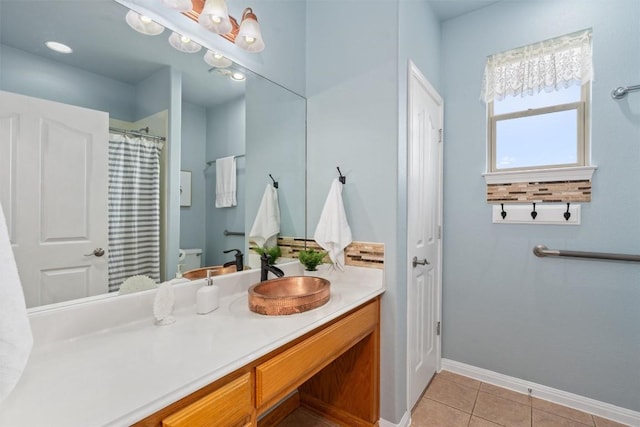 bathroom featuring tile patterned floors, vanity, and toilet