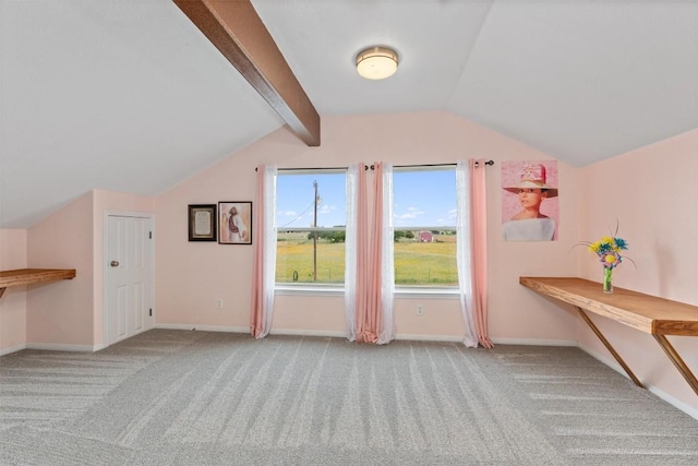 additional living space featuring vaulted ceiling with beams and light carpet