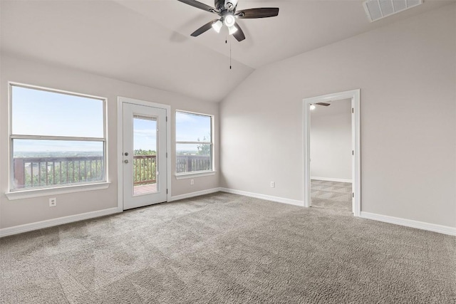 unfurnished room with ceiling fan, plenty of natural light, light carpet, and vaulted ceiling