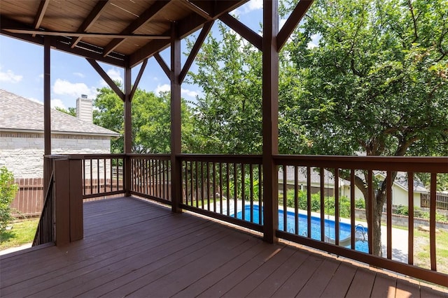 wooden terrace featuring a fenced in pool