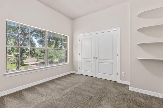 unfurnished bedroom with carpet flooring and a closet