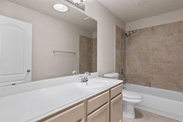 full bathroom featuring tile patterned floors, vanity, toilet, and tiled shower / bath