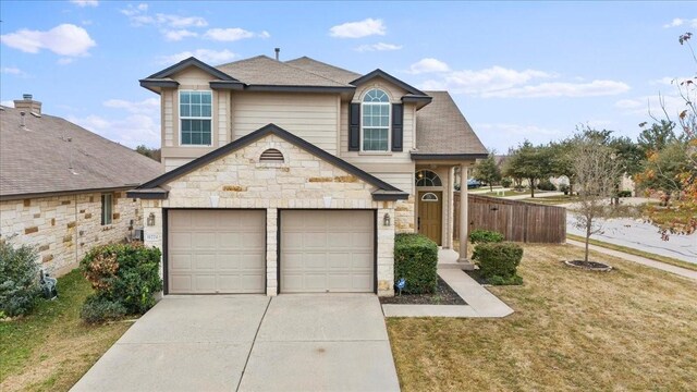 view of front property featuring a garage and a front lawn