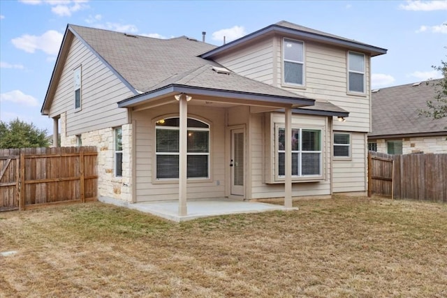 back of property with a patio area and a yard