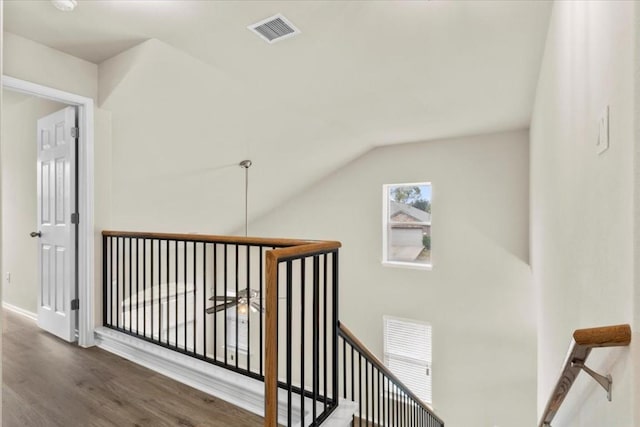 staircase featuring hardwood / wood-style flooring and lofted ceiling