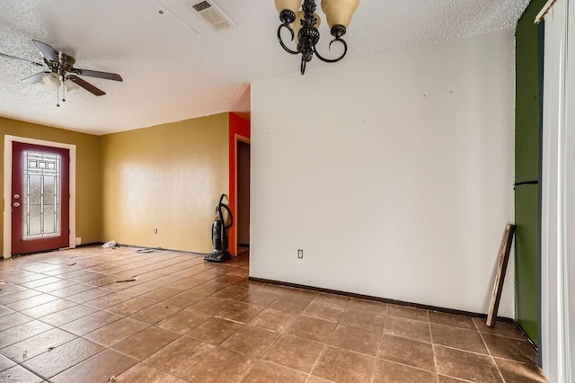 foyer entrance featuring tile patterned flooring, ceiling fan, and a textured ceiling