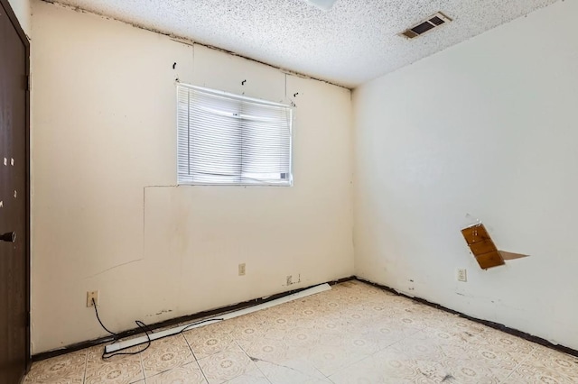 spare room featuring a textured ceiling