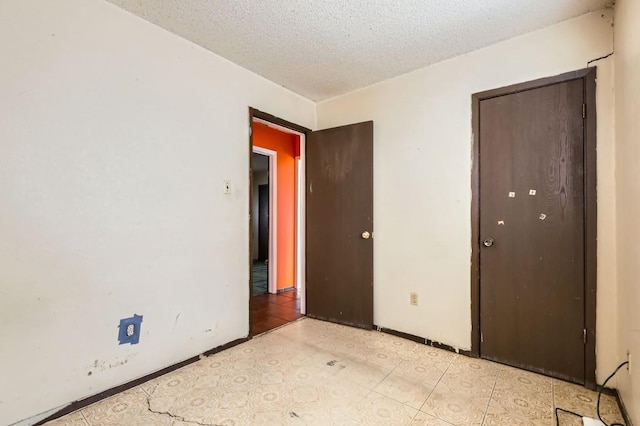 unfurnished bedroom with a textured ceiling