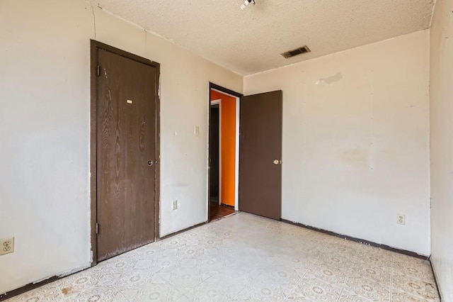 empty room with a textured ceiling