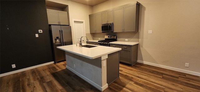 kitchen with gray cabinetry, sink, and stainless steel appliances