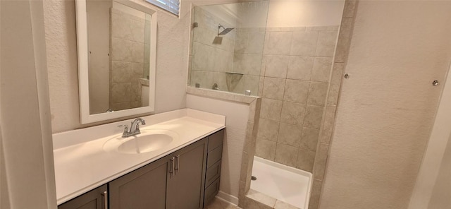 bathroom featuring vanity and tiled shower