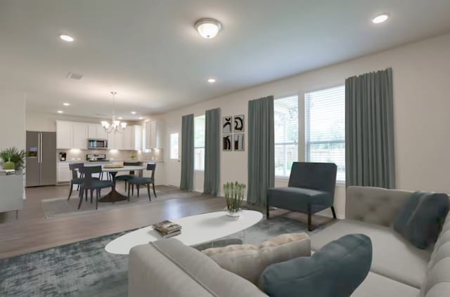 living room featuring hardwood / wood-style floors and a chandelier