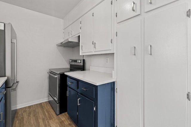 kitchen with appliances with stainless steel finishes, dark hardwood / wood-style flooring, white cabinetry, and blue cabinets