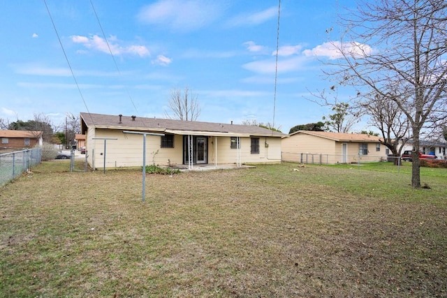 rear view of property featuring a lawn