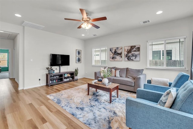 living room with ceiling fan and hardwood / wood-style floors