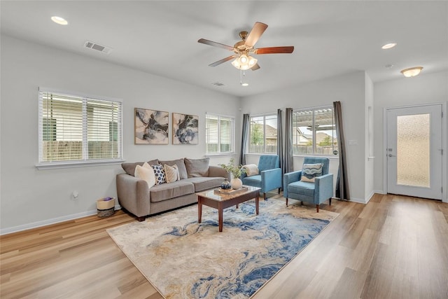 living room with light wood-type flooring and ceiling fan