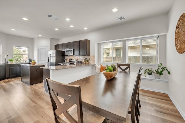 dining space featuring light wood-type flooring