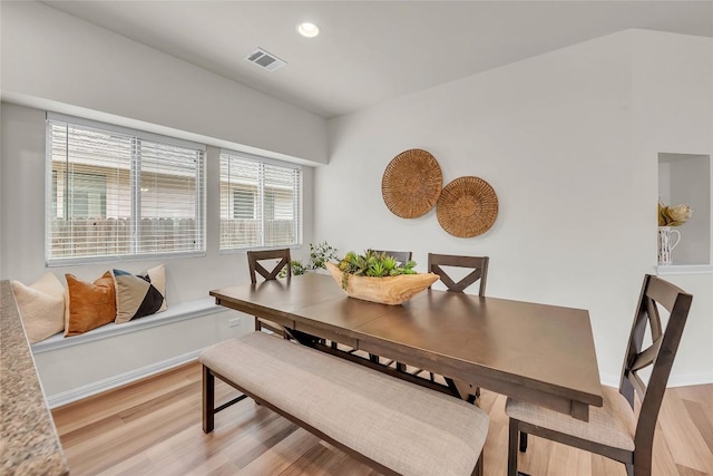 dining space with light hardwood / wood-style flooring