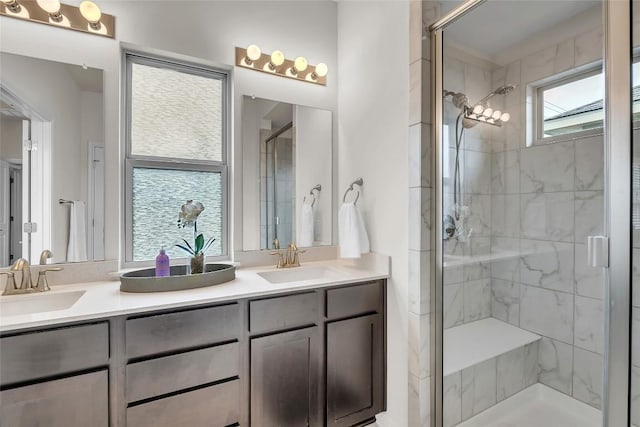 bathroom with vanity, walk in shower, and a healthy amount of sunlight